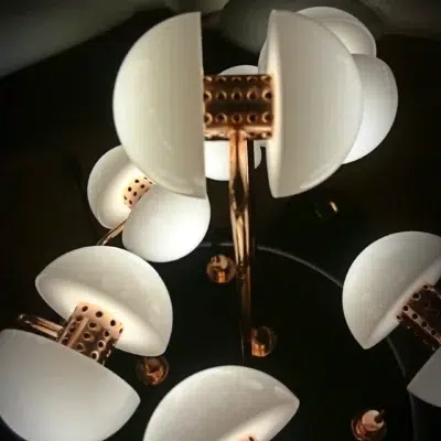Close-up of Germes de Lux sculpture showing porcelain seed-like lights on brass stems