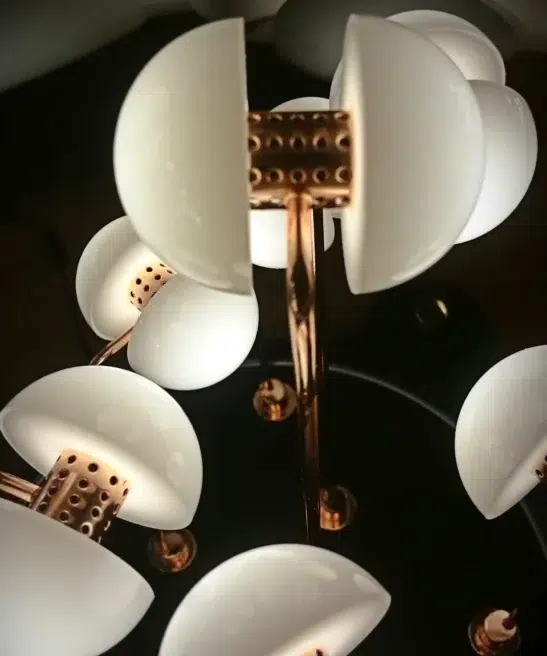 Close-up of Germes de Lux sculpture showing porcelain seed-like lights on brass stems