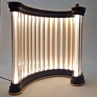 Side view of the Limen light sculpture glowing with golden light.