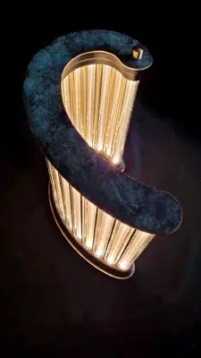 Top view of a golden light column sculpture with brass and plexiglass details.