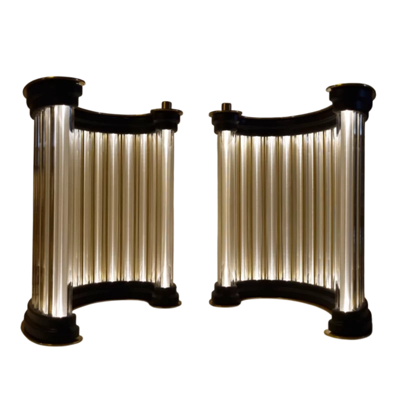 Pair of luminous golden column sculptures displayed together.