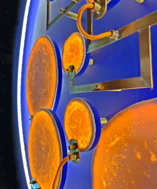 Detail of illuminated porcelain moons in the luminous sculpture Mater Nostra.