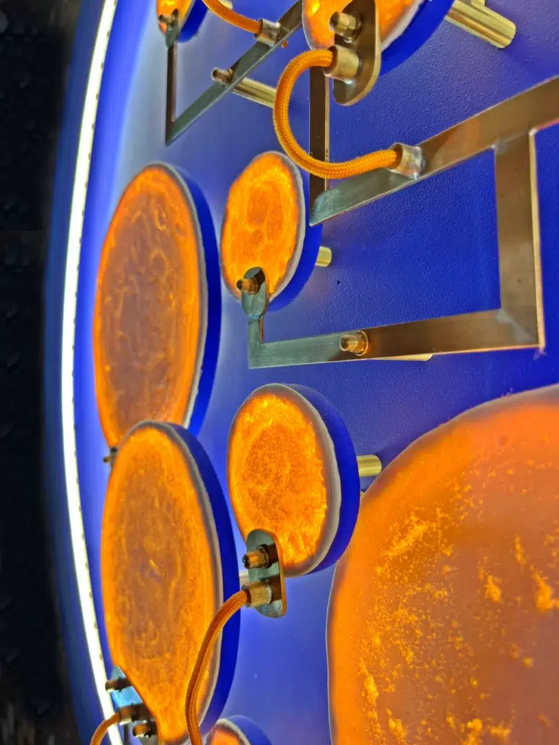 Detail of illuminated porcelain moons in the luminous sculpture Mater Nostra.