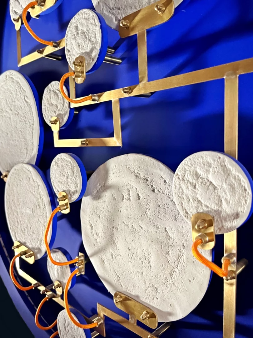 Brass circuit linking the luminous discs of Mater Nostra.