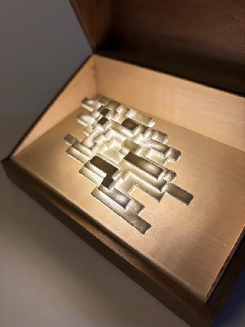 Vapor Minimus illuminated inside an open walnut box, angled view.